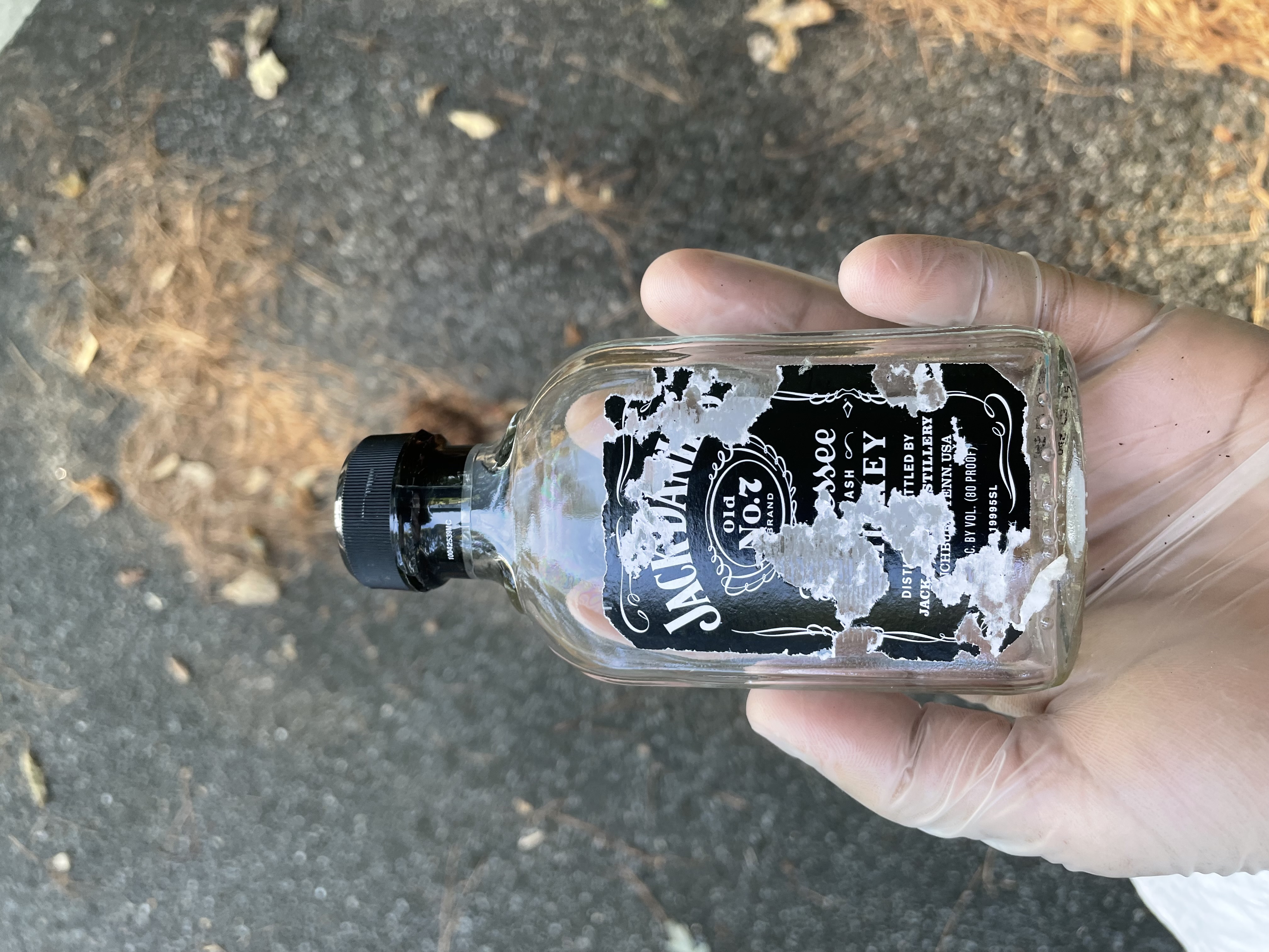 An image of a bottle of whiskey - much of the writing is unintelligible, but it mentions 'Tennessee', 'Whiskey', and 'Jack Danny'. 